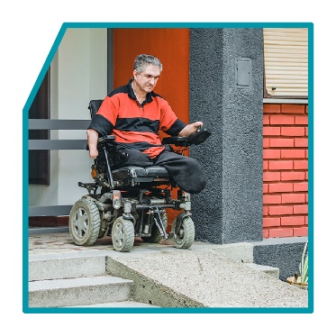 A person with a wheelchair using a ramp.