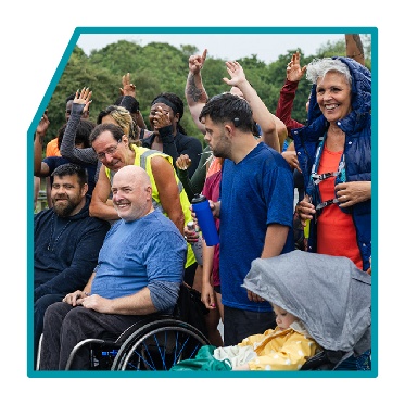 A group of people outside in their community.