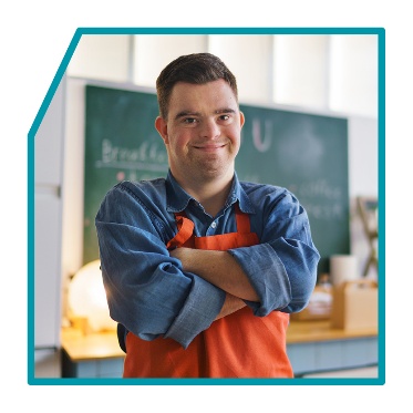 A person smiling with their arms crossed.