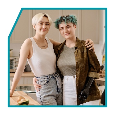 2 LGBTIQA+ people with their arms wrapped around each other.