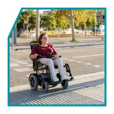 A person with a wheelchair crossing the road.