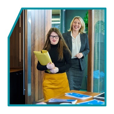 2 people entering an office.