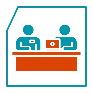 A provider next to someone using a laptop.