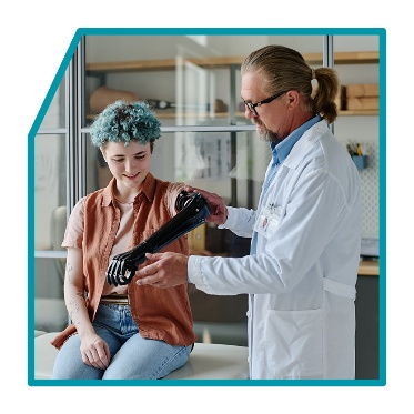 A doctor supporting someone with their prosthetic. 